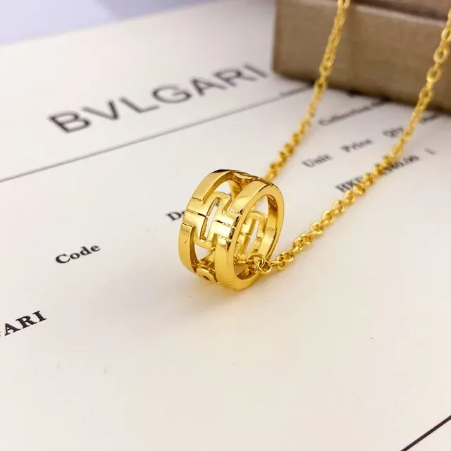 Bvlgari Colar com pingente cilíndrico aberto em ouro e prata com motivo geométrico entrelacado 4