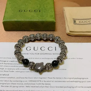 Gucci Ornate Scrollwork Metal and Black Stone Stretch Bracelet