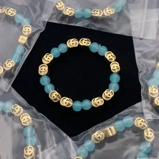 Pulsera Gucci Interlocking G de cuentas Aqua y Oro
