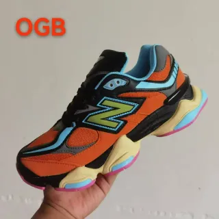 New Balance حذاء رياضي سميك برتقالي متعدد الألوان مع midsole متعدد الألوان ولوحات متعددة الألوان