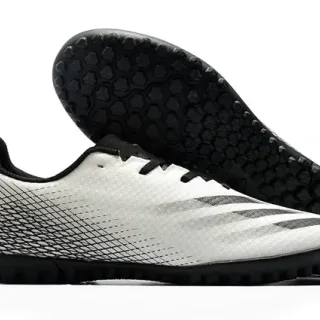 Adidas Sapatos de futebol branco e preto de corte baixo com upper sintético, linha gráfica de gradiente para grama artificial