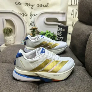 Adidas Chaussures de course en maille blanche et or avec bandes métalliques