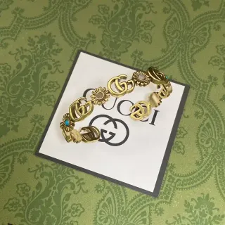 Gucci Interlocking G and Floral Motif Gold-Tone Bracelet