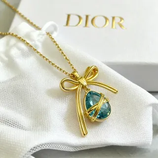 Collier pendentif nœud doré bleu gema goutte facettée de Dior