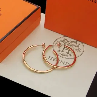Hermès Aretes aro con esmalte rojo y tono dorado