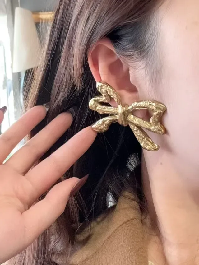 Saint Laurent गोल्ड स्कल्प्टेड बो टेक्सचर्ड मेटल बालियां 2