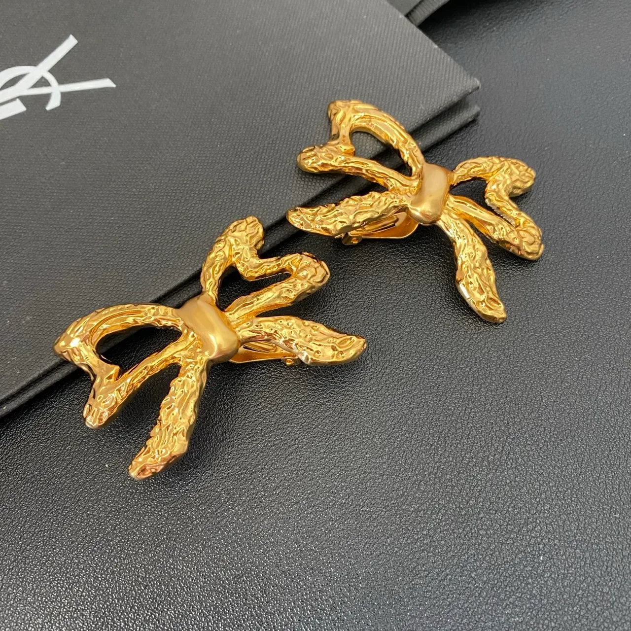 Saint Laurent गोल्ड स्कल्प्टेड बो टेक्सचर्ड मेटल बालियां 9