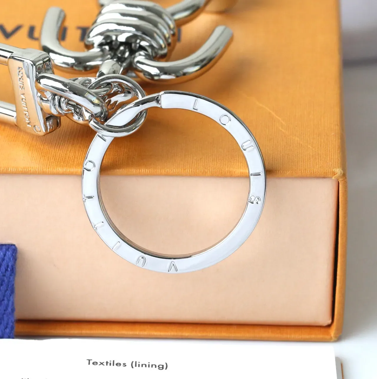 Louis Vuitton Silver Blue Polished Metal Figurine-Shaped Phone Accessory 4