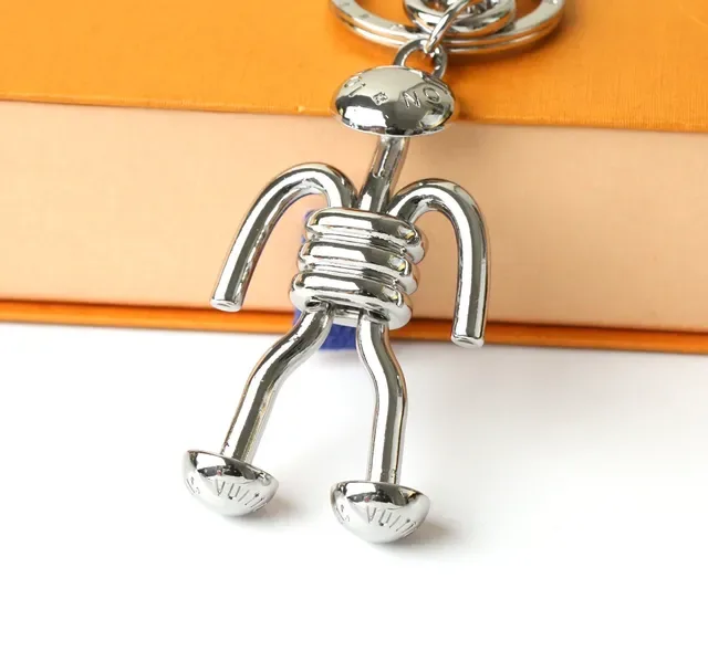 Louis Vuitton Silver Blue Polished Metal Figurine-Shaped Phone Accessory 5