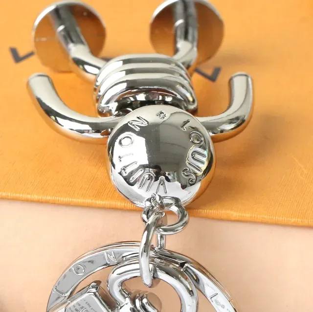 Louis Vuitton Silver Blue Polished Metal Figurine-Shaped Phone Accessory 6