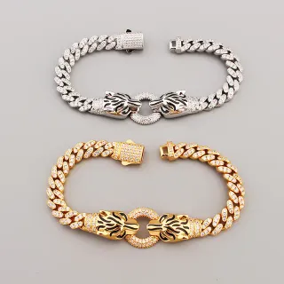 Pulsera de cadena curb-link de plata y oro con broche de cabeza de león