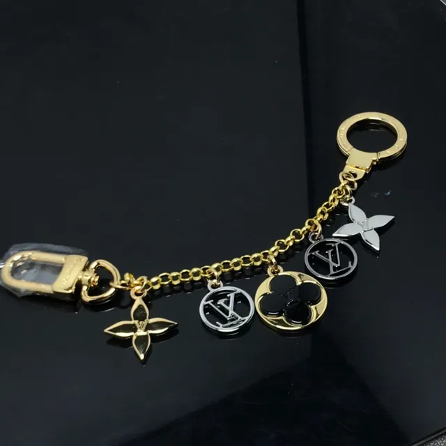 Louis Vuitton Corrente dourada e preta com pendentifs múltiplos pulseira 3
