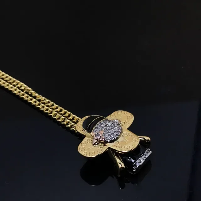 Louis Vuitton Gold Black Monogram-Engraved Clover-Shaped Necklace 4