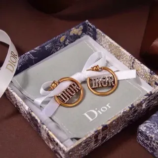 Boucles d'oreilles créoles Dior dorées blanches ornées de cristaux et Logo