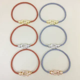 Pulsera de cordón trenzado marrón y azul con cierre en forma de herradura