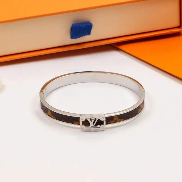 Louis Vuitton bracelet rigide à charnière doré marron avec incrustation cuir monogramme 3