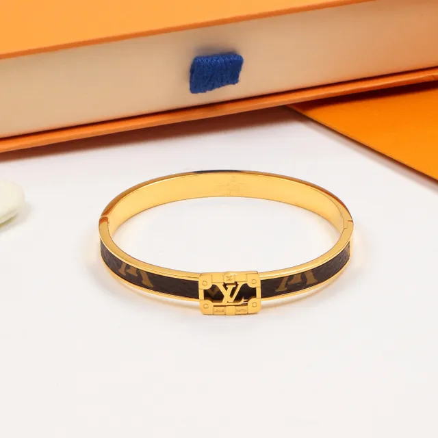 Louis Vuitton bracelet rigide à charnière doré marron avec incrustation cuir monogramme 4