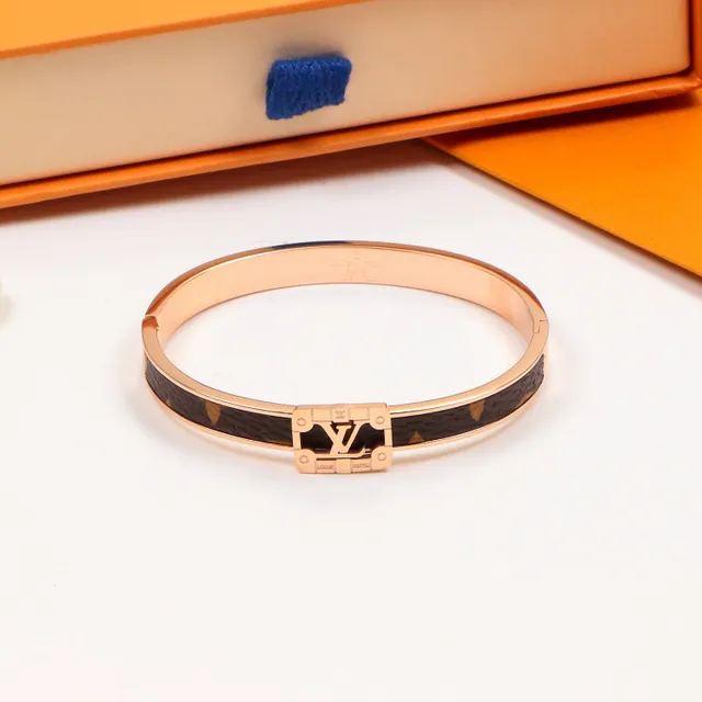 Louis Vuitton bracelet rigide à charnière doré marron avec incrustation cuir monogramme 5