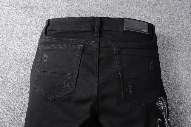 Amiri Motivo de serpente distressed slim-fit calça jeans preta 4