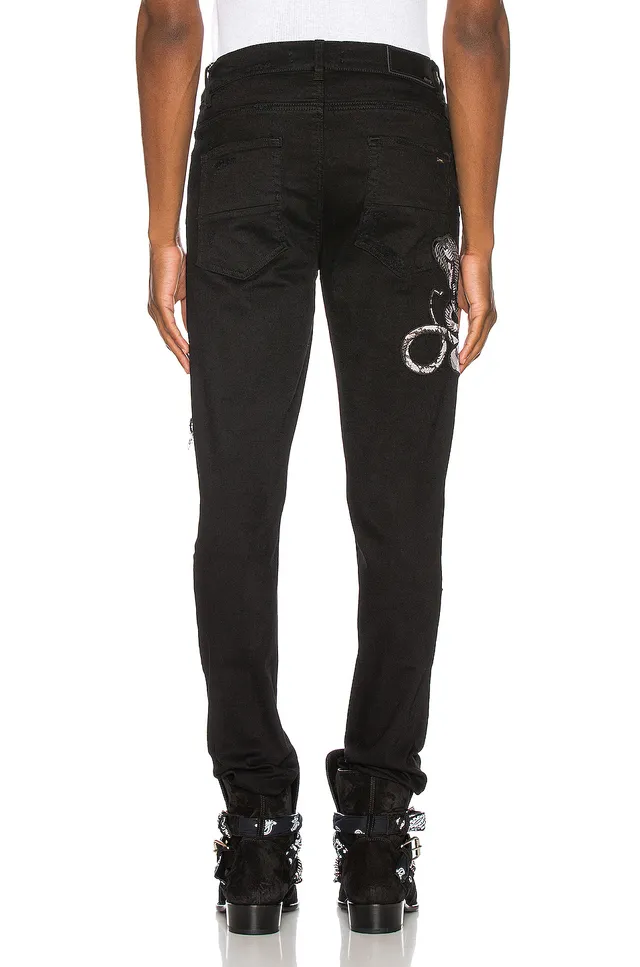 Amiri Motivo de serpente distressed slim-fit calça jeans preta 16