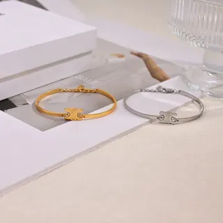 Brazaletes con motivo de monograma en tono dorado y plateado