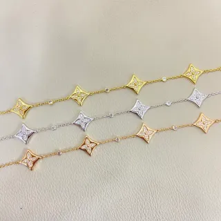 Collier en or et argent avec motifs en forme d'étoile de quatre-feuilles, pierres claires pavé-set