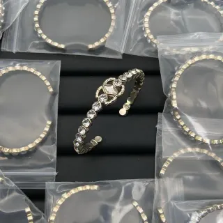 Pulseira de pulso aberta em tom prateado com cristais