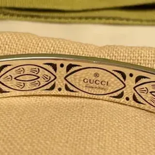Gucci Engraved Eye Motif Gold-Tone Bangle Bracelet