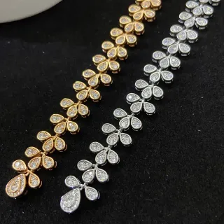 Pulsera de eslabones en forma de lágrima con motivo floral pavé en oro y plata