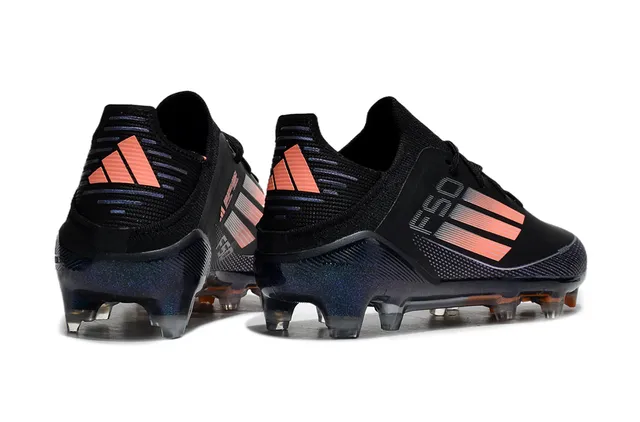 Adidas Zapatos de fútbol de corte bajo con upper sintético negro y naranja con detalles de franjas en gradiente para terreno firme 5