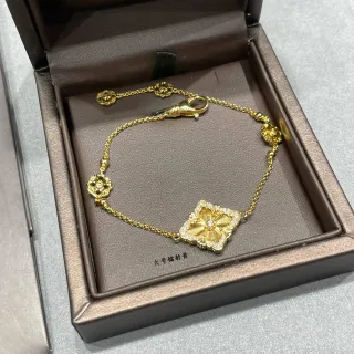 Pulsera de cadena de oro y blanco con motivo floral de centro