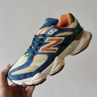 New Balance حذاء رياضي سميك أزرق وبرتقالي وسط طبقي وجزء علوي من الجلد الأصلي والشبكة المختلطة