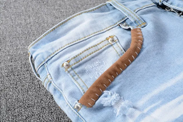 Amiri Patchwork Distressed Logo Jeans 5