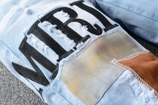 Amiri Patchwork Distressed Logo Jeans 6
