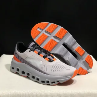 On Cloudmonster gris naranja zapatillas de correr