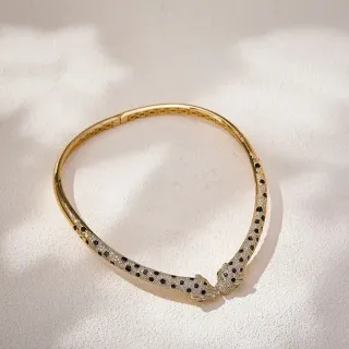 سوارة ذهبية Pavé برأس حيوان مزدوج