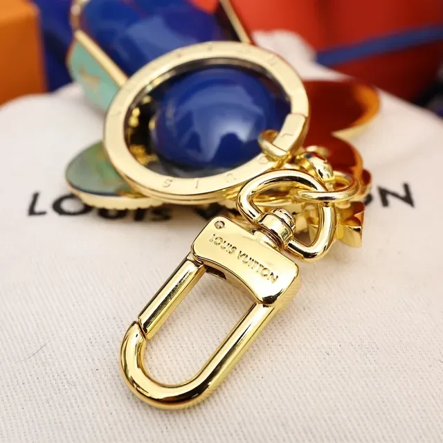 Louis Vuitton Broche com Encanto Floral Chaveiro em Ouro e Cristal Azul 5