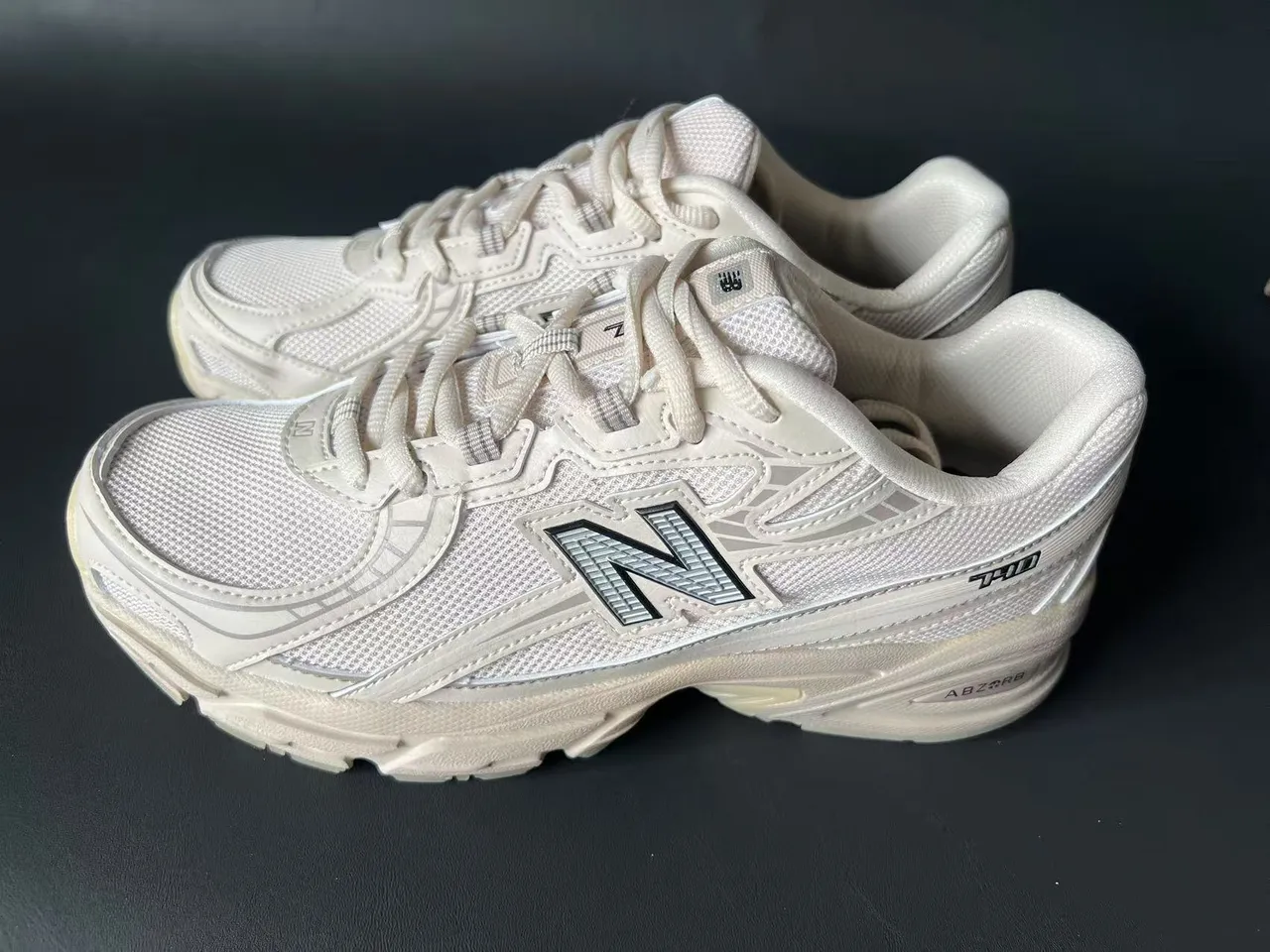 New Balance حذاء رياضي سميك بلون بيج وجري مع وسط شبكي وطبقة سينثيتيك 3